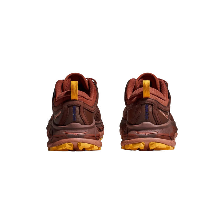 Rear view of Hoka's U Tor Ultra Lo shoes in Spice/Hot Sauce colors, featuring orange soles and yellow pull tabs.