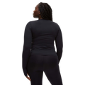 A person with long braided hair wears a fitted Rohnisch Jacquard Long Sleeve Tee, made from moisture-wicking recycled polyester, and black pants, facing away from the camera.