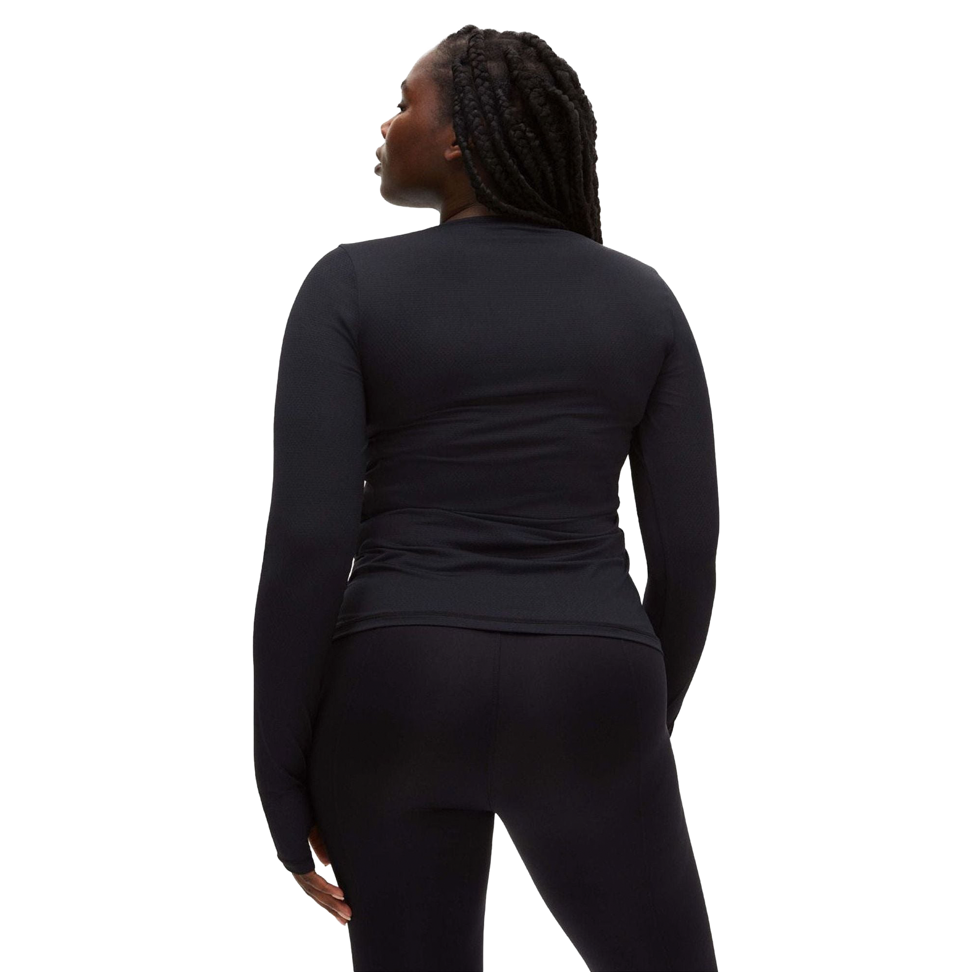 A person with long braided hair wears a fitted Rohnisch Jacquard Long Sleeve Tee, made from moisture-wicking recycled polyester, and black pants, facing away from the camera.