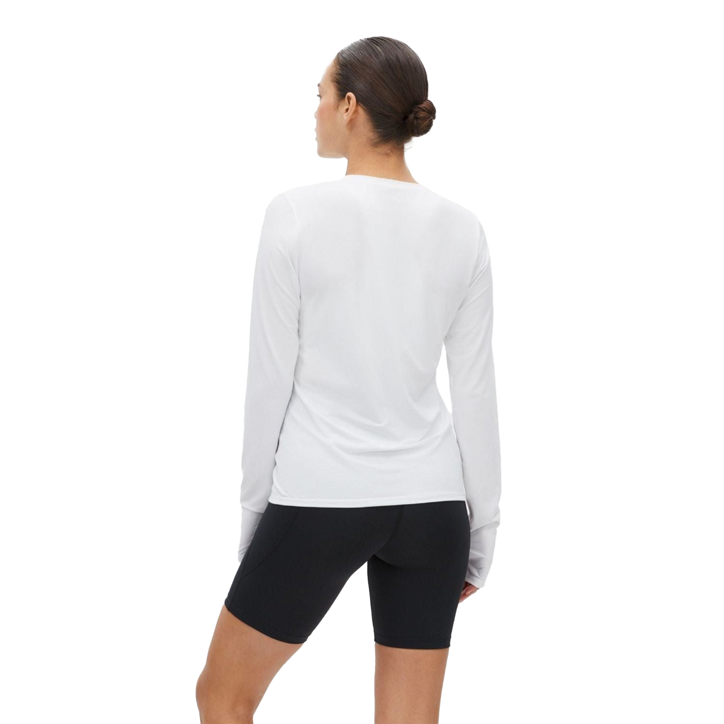 A person with a bun is facing away, wearing a Rohnisch Jacquard Long Sleeve Tee in white and black shorts against a black background.