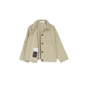 The Jules Jacket by Aiayu is displayed against a white background, featuring a beige design with large black buttons, crafted from weather-resistant Ventile fabric. It includes a left-side pocket and visible inner labels.