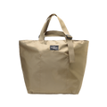 The Large Double Handle Tote by Bags in Progress is a beige bag made from woven nylon, featuring short double handles and a small front label.