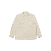 A Universal Works LS Utility Shirt in beige, made from 100% cotton, showcases long sleeves and button flap chest pockets while laid flat against a black background.