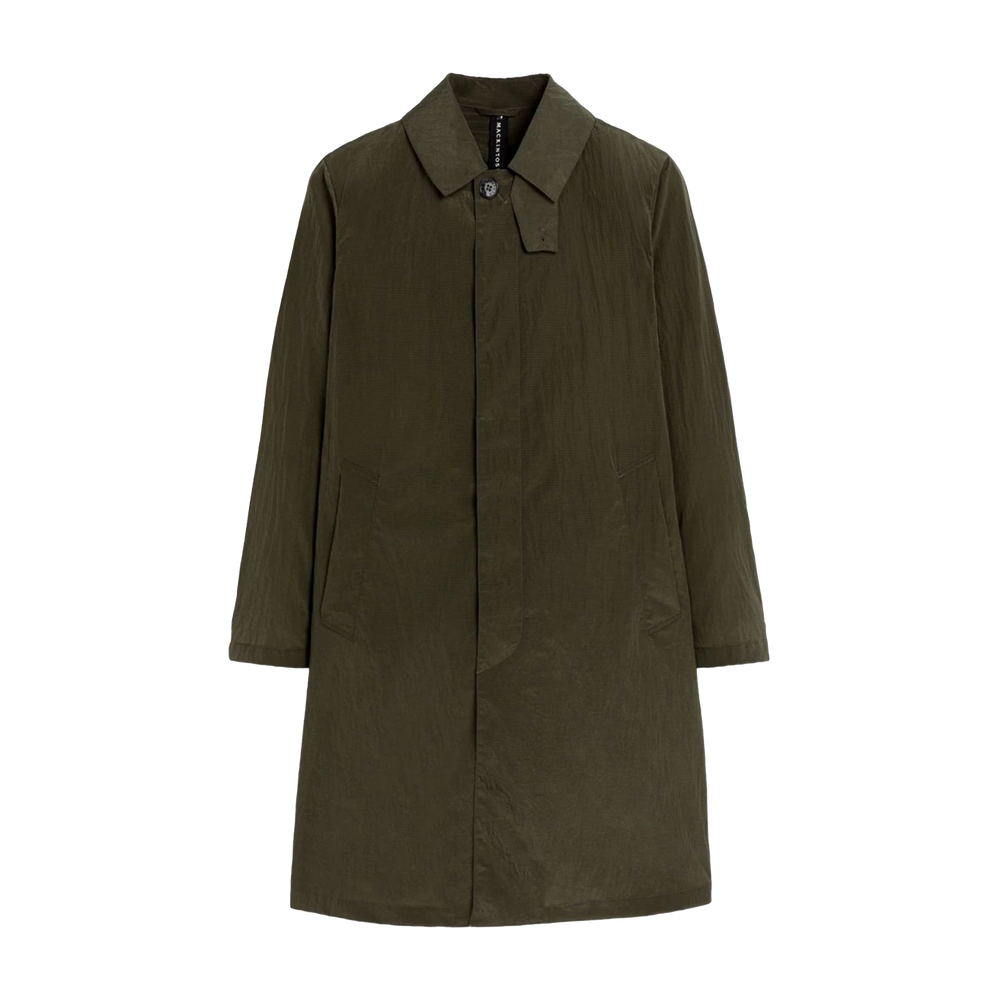 The Mackintosh M Shower Rain Coat in olive green is ideal for travel. It features a collar, button closure, and two pockets. Its water-repellent design keeps you stylish and dry on any adventure.