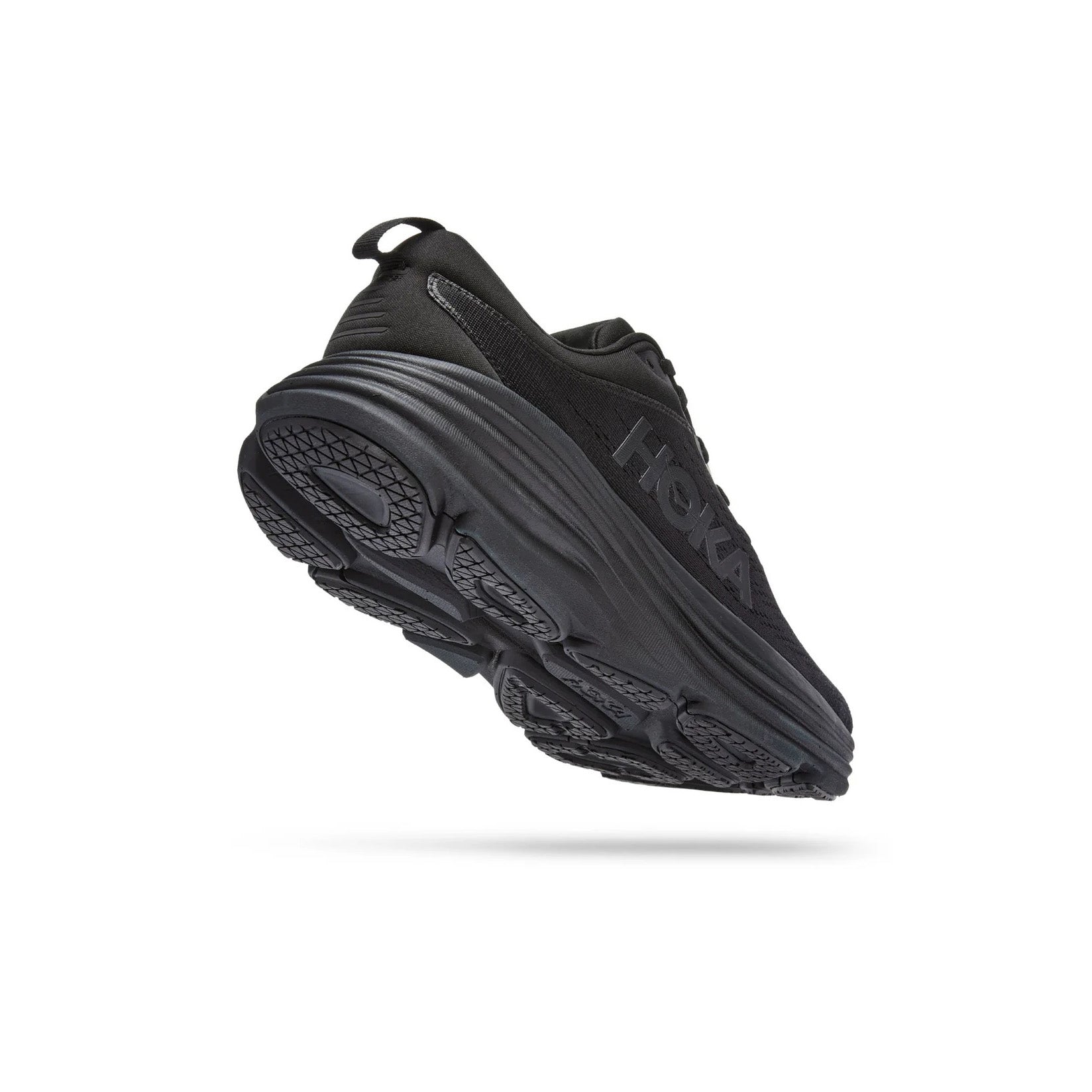 The Hoka W Bondi 9 in Black/Black is shown angled on a white background, featuring thicker, softer foams, an extended heel geometry, a textured tread pattern, and the side logo.