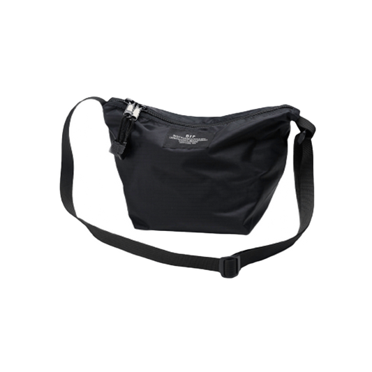 The Micro Tote by Bags in Progress is a lightweight black shoulder bag made from nylon, featuring a zipper closure and an adjustable strap, beautifully photographed against a white background.