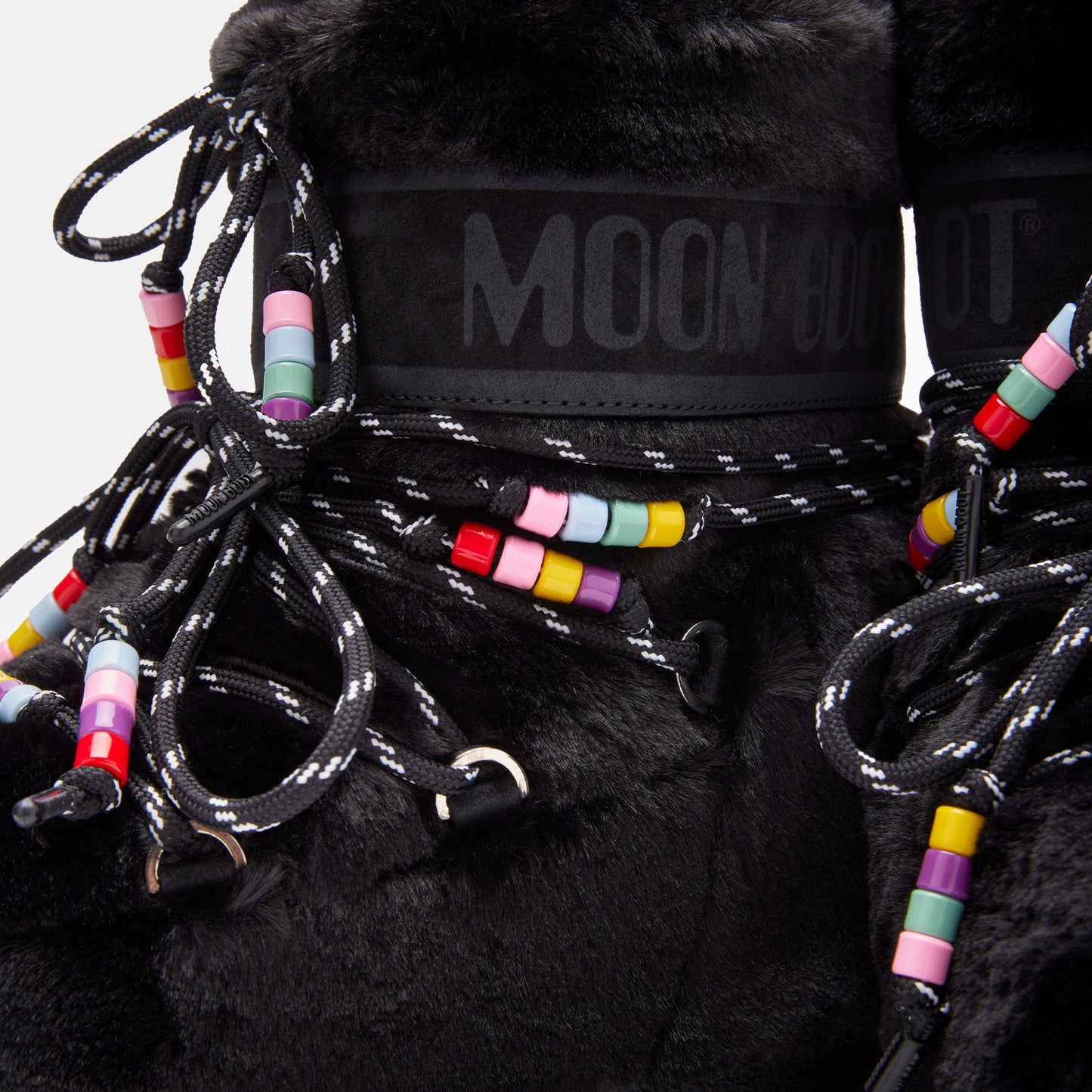 Black fuzzy Icon Low Faux Fur Beads boots with laces and multicolored bead decorations, featuring a "Moon Boot" brand label near the top.