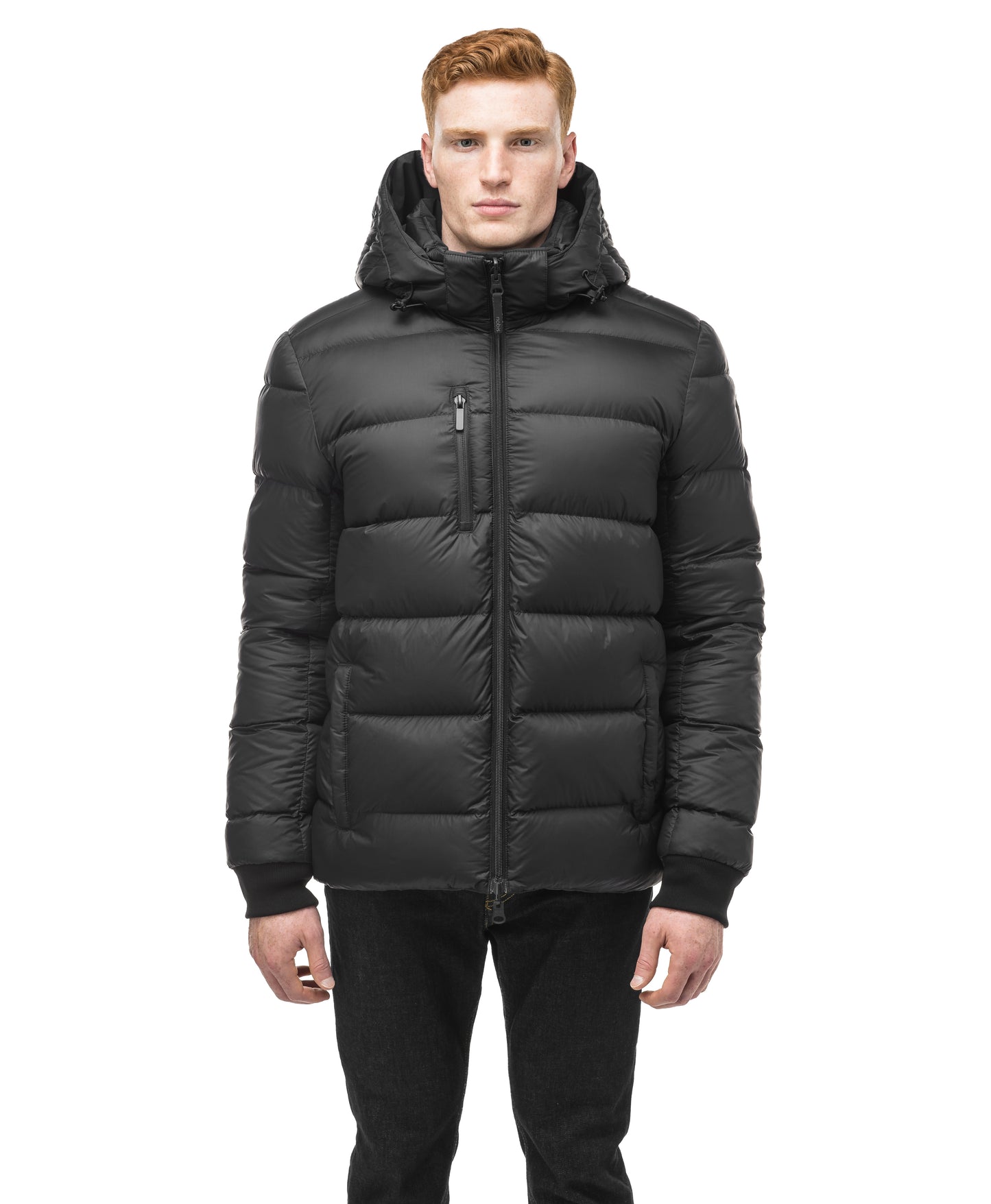 Oliver, in the Nobis Oliver Men's Reversible Puffer Jacket paired with black jeans, effortlessly transitions from day to night against a crisp white backdrop.