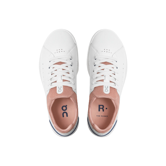 A pair of On Running W The Roger Advantage sneakers in White/Rose, featuring pink mesh tongues, white laces, and "ON" branding on the insoles. Tennis-inspired and designed for stability and comfort; shown from above on a white background.