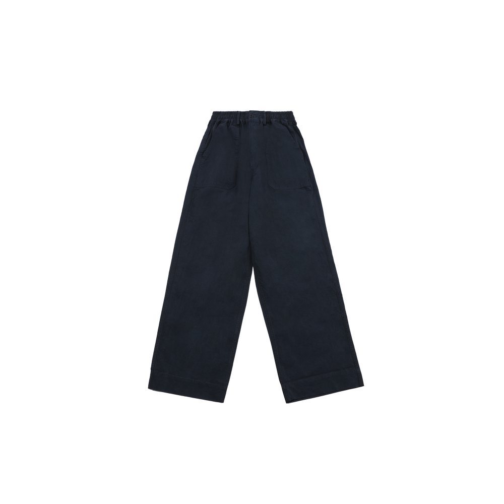 The One Tuck Wide Fatigue Pant by Kappy is a unisex, one size fits most design in navy blue, featuring wide legs, an elastic waistband, and large front pockets. It's showcased against a plain background.
