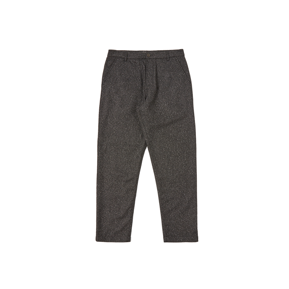Presented on a simple backdrop, the Oxford Pant by Universal Works highlights classic tailoring with its high-quality wool fabric and button closure, providing an enduring style.
