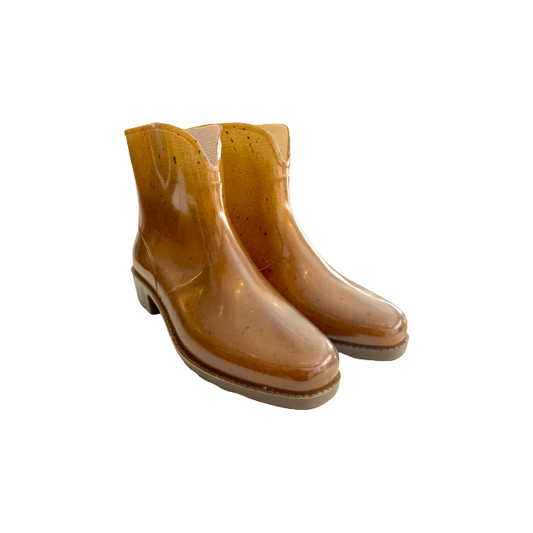 The Cityana Ankle Boot, Doubure Ecru by Plasticana is a pair of glossy, waterproof ankle-length boots made from recyclable hemp plastic.