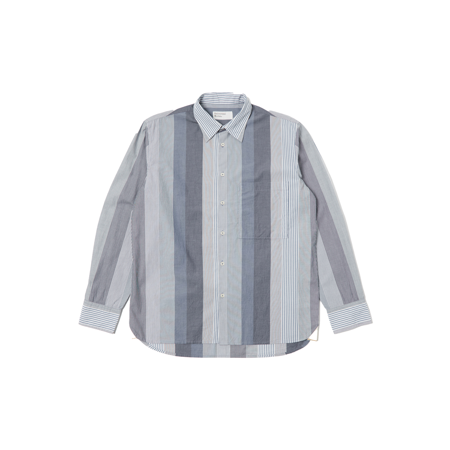 The Square Pocket Shirt by Universal Works features a relaxed fit with long sleeves and a contemporary shape, showcasing vertical stripes in shades of blue and gray. Made from 100% cotton, it is displayed against a plain background.