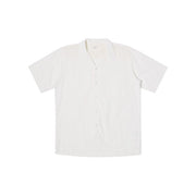 A white Camp Shirt from Universal Works, featuring a relaxed fit with short sleeves and an open collar, is displayed laid flat on a white background.