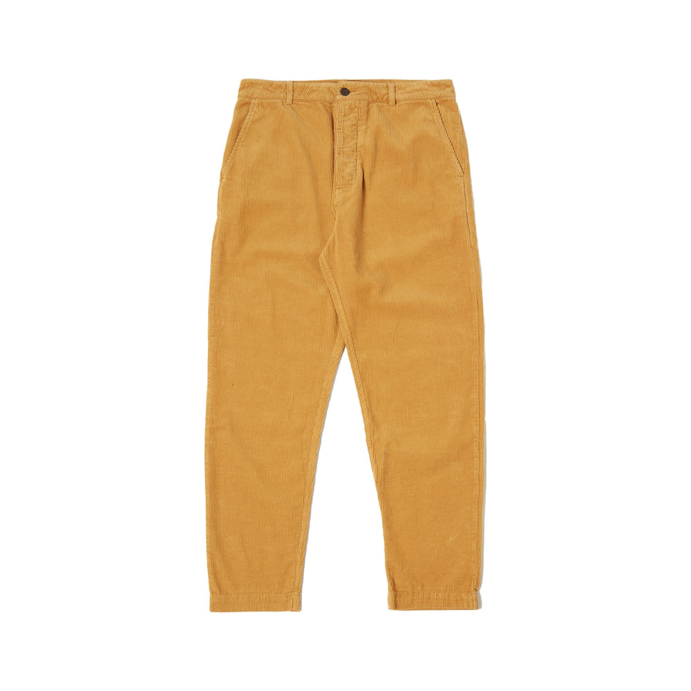 Universal Works' Military Chino Corduroy in Corn features a relaxed fit with front button and zipper, mid-rise design, and two side pockets, making these military-inspired trousers perfect for any casual outing.
