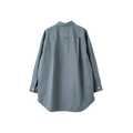 Back view of the Margaret Howell W Oversized Painters Shirt, a long-sleeved garment in a blue-gray shade, made from compact cotton poplin. It features tapered sleeves and is designed with a collar and buttoned cuffs.