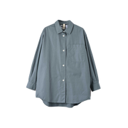 Introducing the W Oversized Painters Shirt by Margaret Howell - a loose-fitting shirt crafted from compact cotton poplin in light blue. It features a single chest pocket, white buttons, and tapered sleeves, beautifully showcased against a white background.