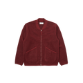 Universal Works introduces the Zip Bomber Fleece, a red jacket designed with a two-way zip and a simple collar. It is crafted in a regular fit and includes two front pockets for practicality.
