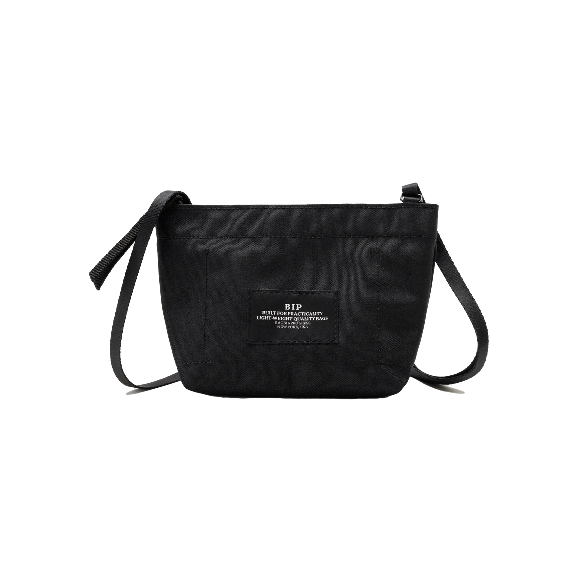 The Zipper Pouch Mini by Bags in Progress is a compact black shoulder bag made from recycled polyester, showcasing a front patch adorned with white text.