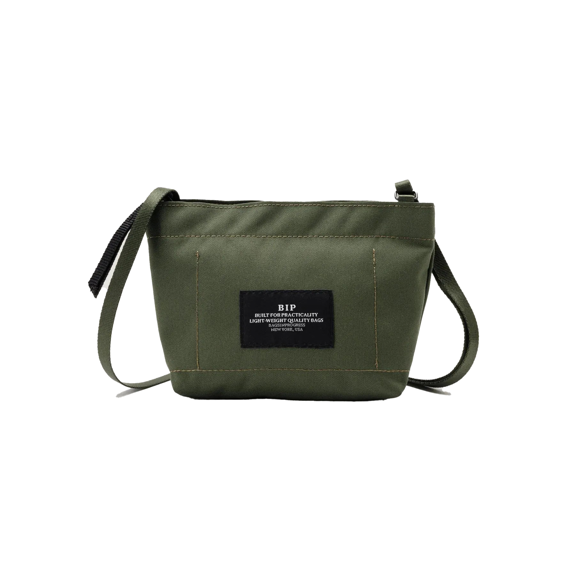 The Zipper Pouch Mini by Bags in Progress is a mini shoulder bag in olive green made from recycled polyester. It includes a black label on the front with text and offers water-repellent protection, featuring a single zip closure and an adjustable black strap, ideal for everyday use.